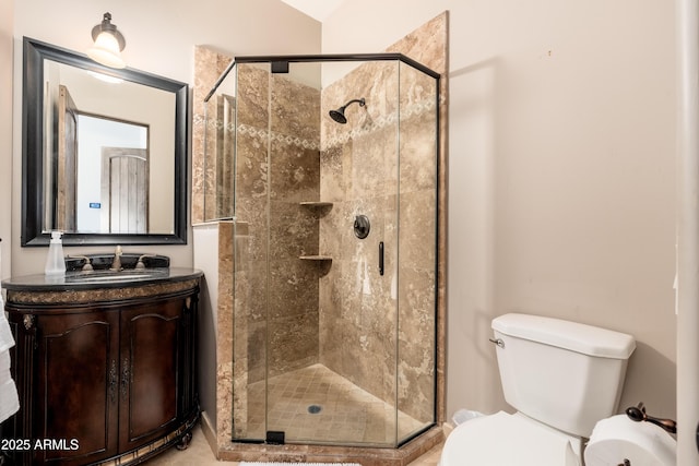 bathroom with an enclosed shower, vanity, and toilet