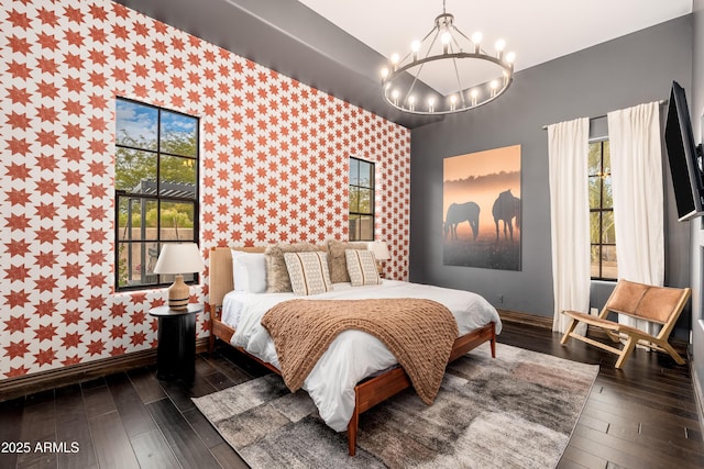 bedroom featuring dark wood-type flooring and a notable chandelier