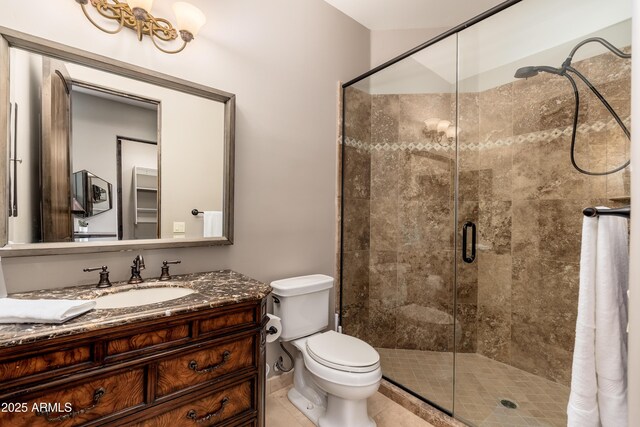 bathroom with vanity, an enclosed shower, and toilet