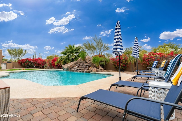 view of pool with pool water feature and a patio area