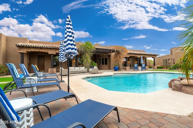 view of swimming pool featuring an outdoor living space and a patio area