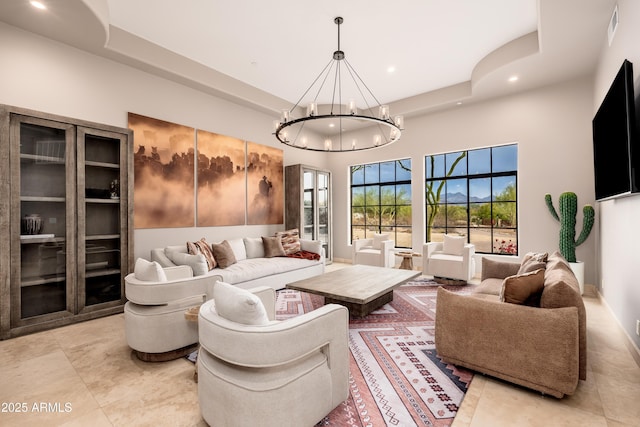 living room featuring a high ceiling and a notable chandelier