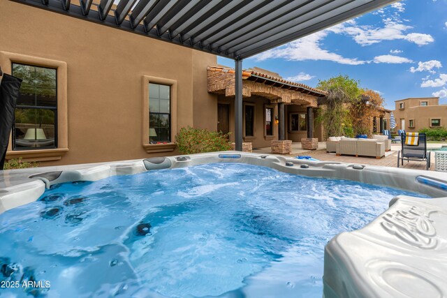 view of pool with a hot tub and outdoor lounge area