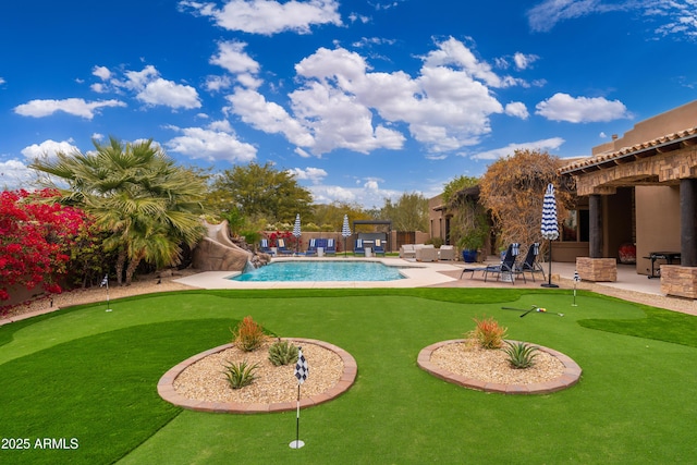 view of swimming pool with a patio and a water slide