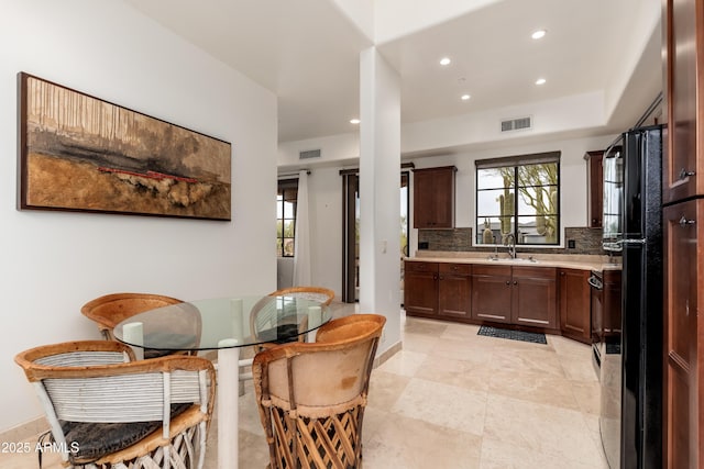 kitchen featuring stove, sink, and backsplash