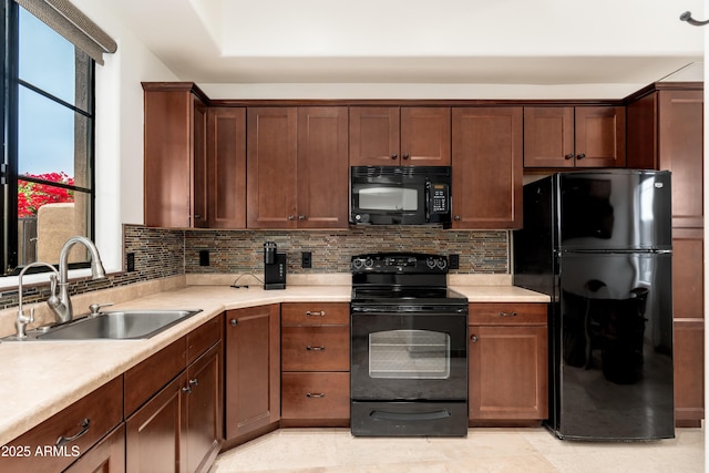 kitchen with sink, decorative backsplash, and black appliances