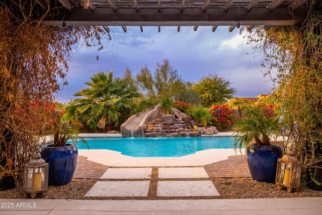 view of swimming pool featuring a patio and a water slide