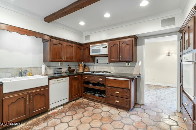 kitchen featuring beam ceiling, crown molding, sink, and white appliances