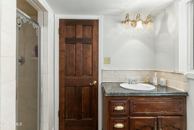 bathroom featuring vanity and a shower with door