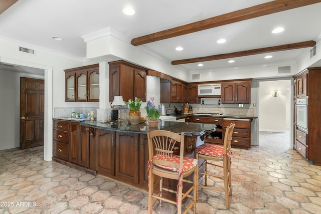 kitchen featuring beamed ceiling, dark brown cabinetry, kitchen peninsula, crown molding, and white appliances