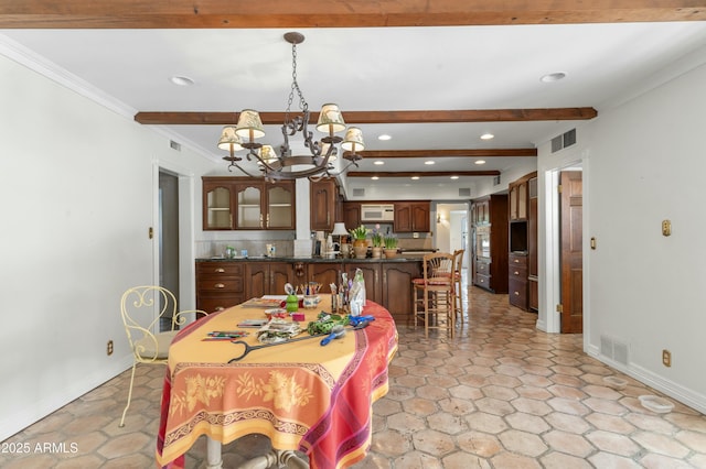 dining room with ornamental molding, a notable chandelier, and beam ceiling