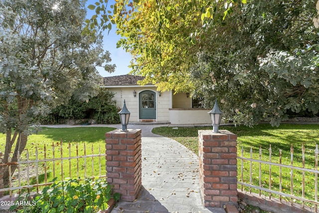 obstructed view of property featuring a front yard