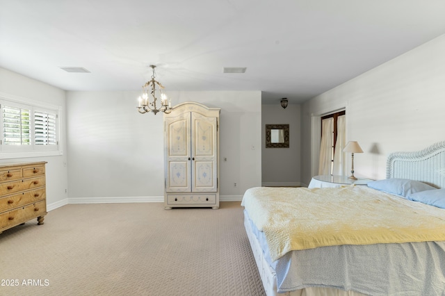 bedroom featuring light carpet and a chandelier