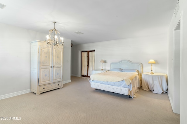 bedroom featuring an inviting chandelier and light carpet