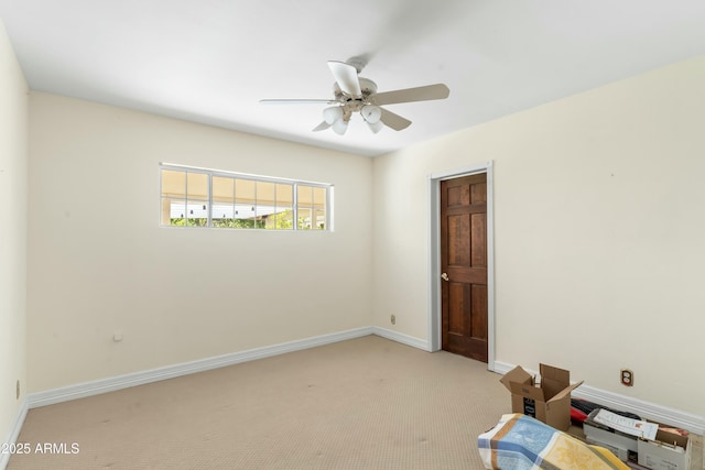 spare room featuring light carpet and ceiling fan