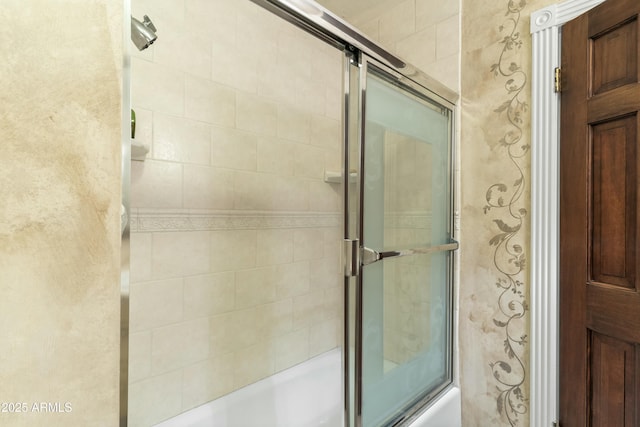 bathroom featuring bath / shower combo with glass door