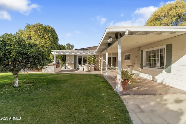 back of property with a patio, a lawn, and french doors