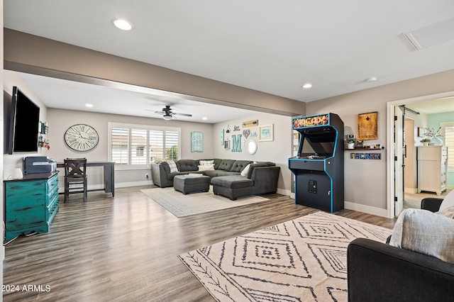 living room featuring hardwood / wood-style floors and ceiling fan