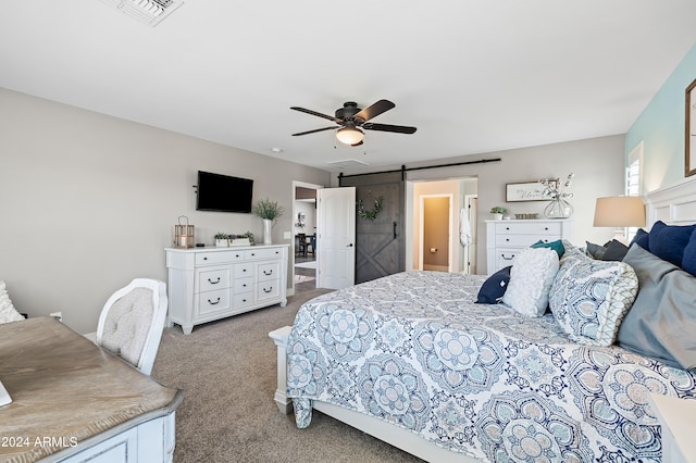 bedroom with a barn door, ceiling fan, and light colored carpet