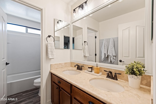 bathroom with hardwood / wood-style floors, vanity, and toilet