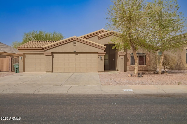 view of front of property featuring a garage, concrete driveway, and stucco siding