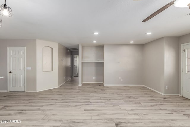 empty room featuring light wood-style flooring, baseboards, and recessed lighting