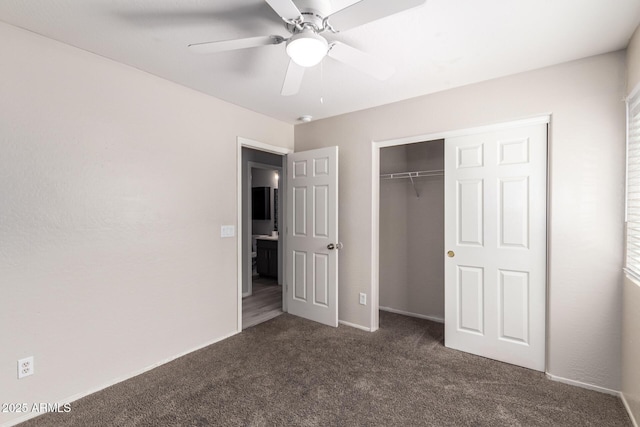 unfurnished bedroom featuring a closet, dark carpet, and ceiling fan