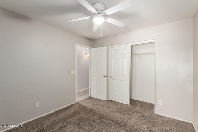 unfurnished bedroom with ceiling fan, a closet, baseboards, and carpet flooring