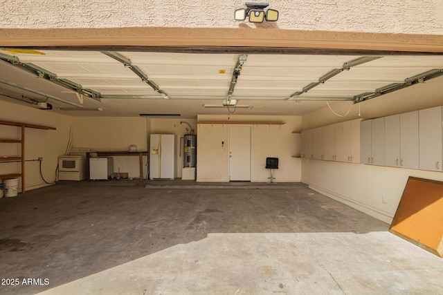 garage with water heater, white refrigerator with ice dispenser, washer and dryer, and a garage door opener