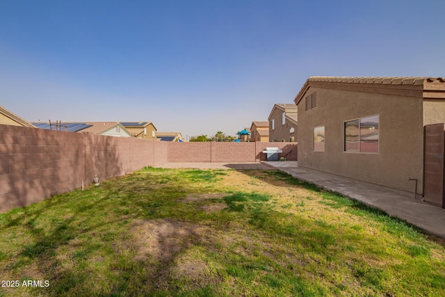 view of yard with a patio area and a fenced backyard