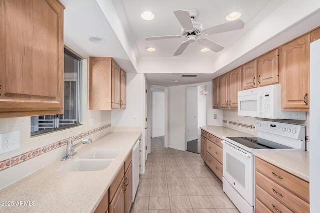 kitchen with light tile patterned flooring, sink, a raised ceiling, white appliances, and backsplash