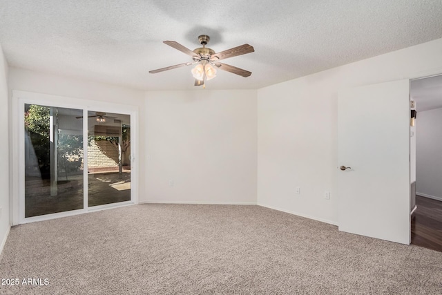 carpeted spare room featuring ceiling fan and a textured ceiling