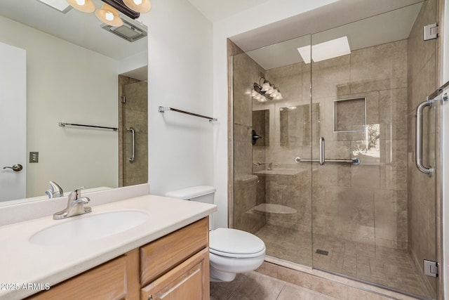 bathroom with tile patterned flooring, vanity, an enclosed shower, and toilet