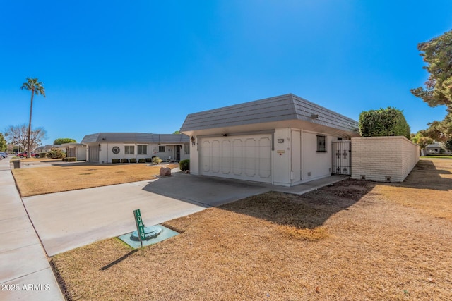 view of front of house with a garage and a front lawn