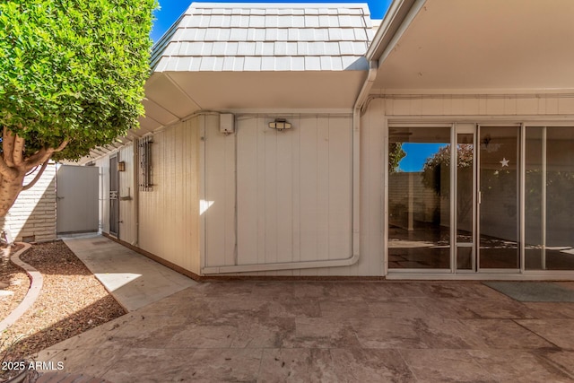 view of exterior entry featuring a patio area