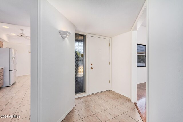 foyer entrance featuring ceiling fan and light tile patterned floors