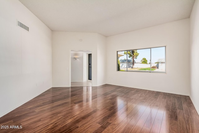 empty room with dark wood-type flooring