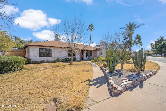 ranch-style house featuring a front lawn