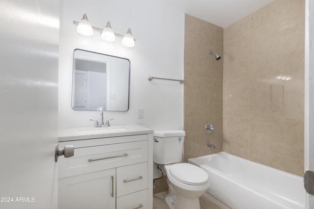 full bathroom featuring vanity, tiled shower / bath combo, and toilet