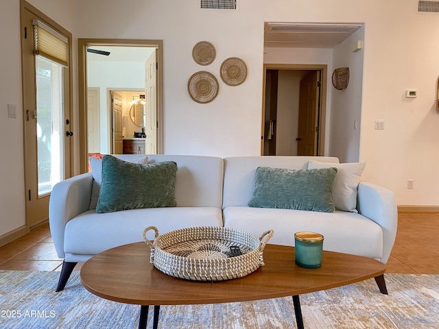 living room with visible vents, plenty of natural light, and light tile patterned floors