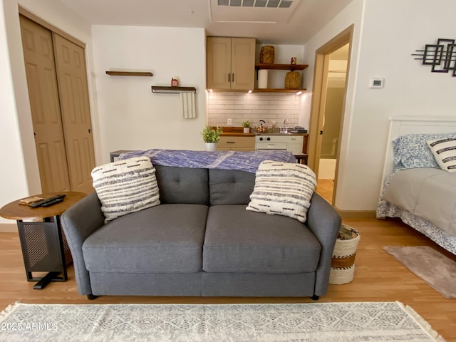 bedroom featuring a closet, visible vents, and light wood-style flooring