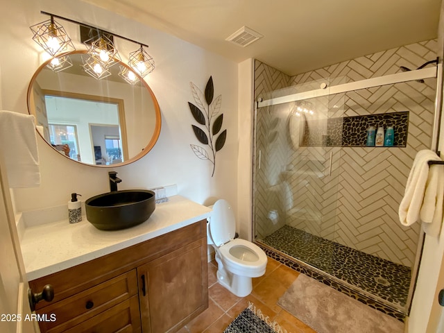 full bath with toilet, vanity, visible vents, tile patterned floors, and a stall shower