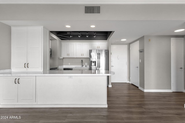 kitchen featuring white cabinetry, stainless steel fridge, sink, and dark hardwood / wood-style floors