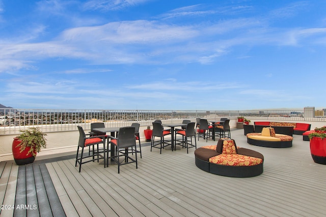 wooden deck with an outdoor hangout area and a water view