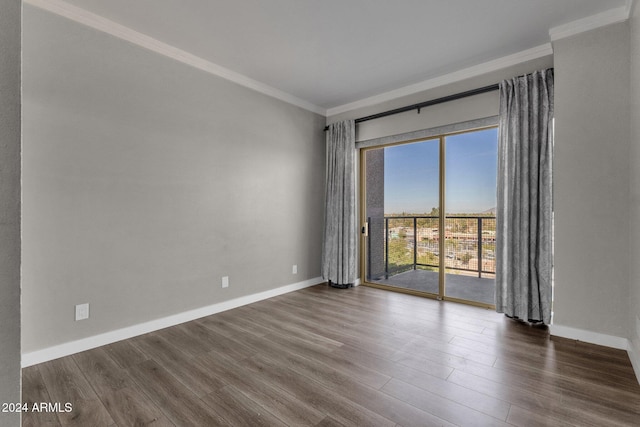 unfurnished room featuring dark hardwood / wood-style floors and ornamental molding