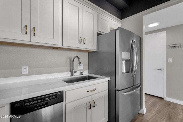 kitchen featuring sink, white cabinets, and stainless steel appliances