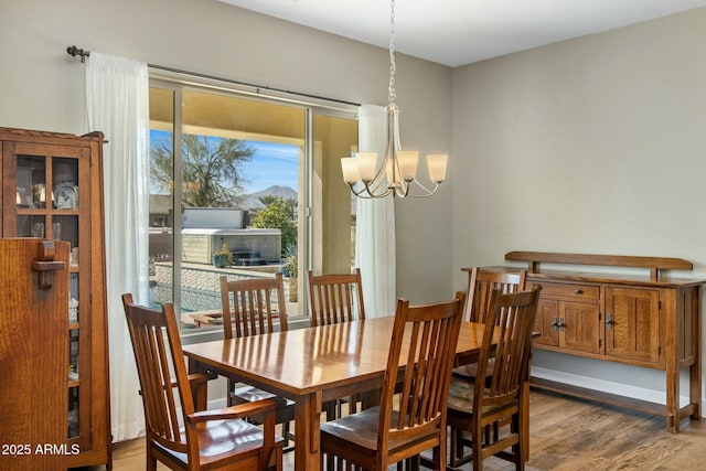 dining room with a chandelier and wood finished floors