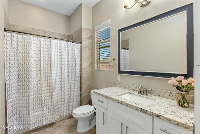 bathroom featuring curtained shower, tile patterned flooring, vanity, and toilet