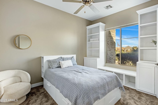 bedroom with visible vents, dark carpet, baseboards, and ceiling fan