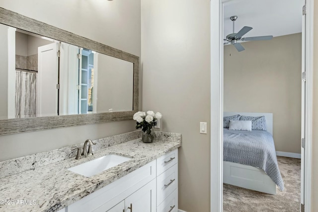 ensuite bathroom featuring baseboards, a ceiling fan, a shower with shower curtain, connected bathroom, and vanity